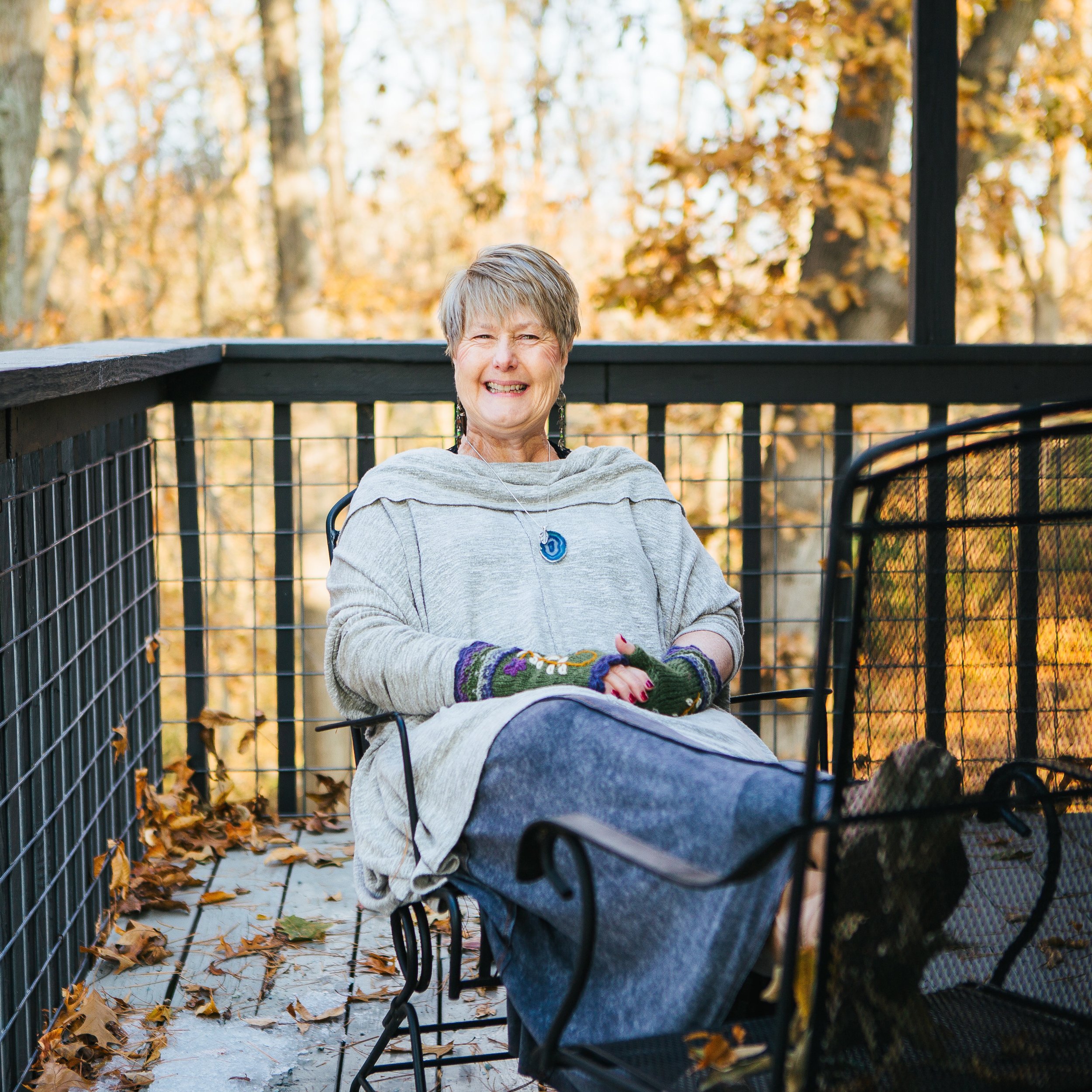 Donna smiling warmly, surrounded by the creative materials she loves