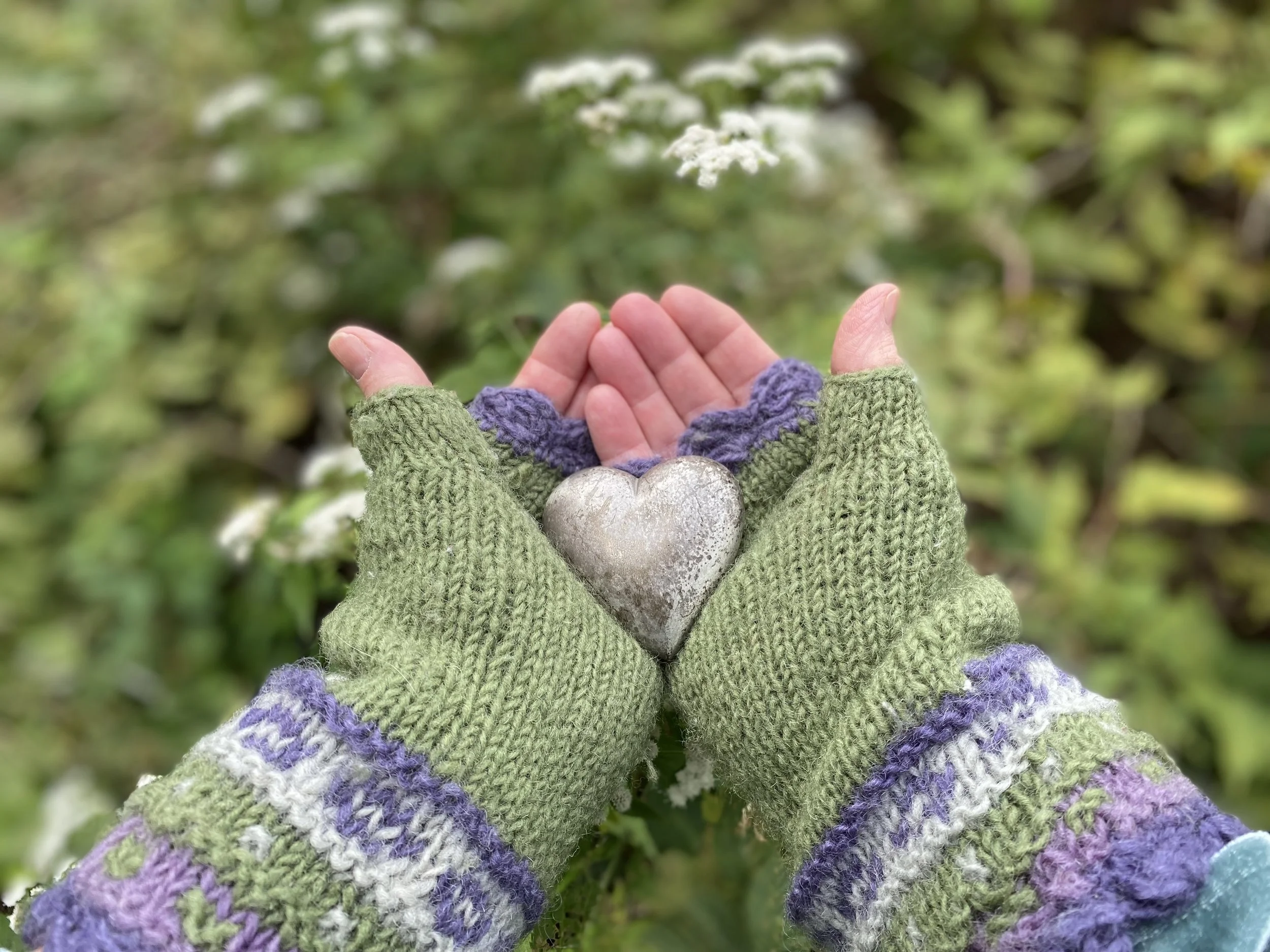 Hands at work in a River Roots workshop, surrounded by natural materials and creative tools